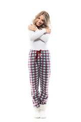 Delicate young cuddly woman in pajamas embrace herself remembering memories. Full body length isolated on white background.
