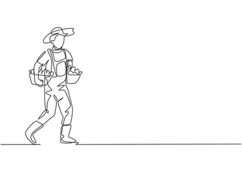 Single continuous line drawing male farmer carrying boxes and baskets of fruit in his right and left hands. Successful harvest minimalism concept. One line draw graphic design vector illustration