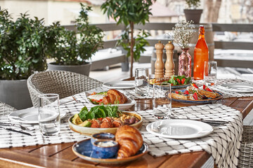 traditional breakfast with croissants and coffee served on wooden table. French breakfast.