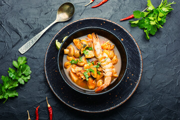 Tom yum soup with seafood and coconut milk,top view