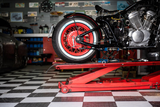 motorcycle raised on the platform to be repaired in a mechanic's shop. mechanics concept. vintage motorcycle