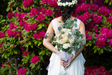 Bride Holding a Wedding Bouquet Of Roses Back Facing  at Wedding Ceremony
