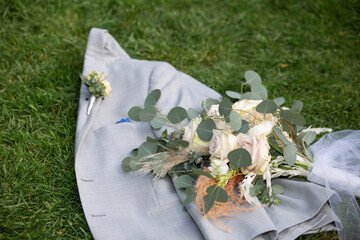 Tuxedo Coat with Wedding Bouquet of Roses on Grass