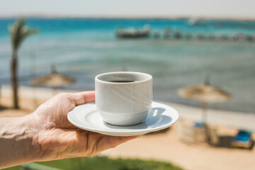Man hands holding cup of coffee. Good morning sunrise concept. Lets start a new day. Space for text