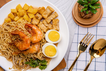 Mie rebus medan or Noodle Soup 

The dish is made of yellow egg noodles, which are also used in Hokkien mee, with a spicy slightly sweet curry-like gravy. The gravy is made from shrimp or tauchu broth