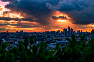 Fototapeta premium The high angle background of the city view with the secret light of the evening, blurring of night lights, showing the distribution of condominiums, dense homes in the capital community