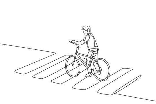 Single one line drawing of a young man riding a bicycle crossing the zebra crossing at a crossroads.