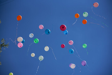balls of different colors on blue sky