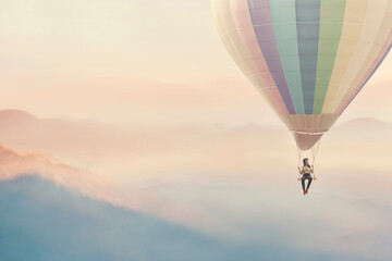 surreal woman enjoying herself on a swing hanging from a hot air balloon