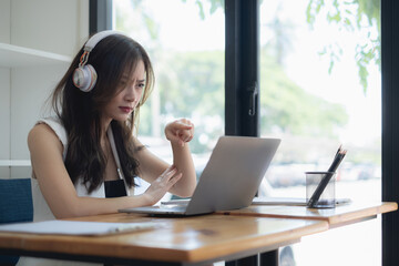 Online video conference and Digital meeting. Business woman discussing business with team by video conference in home office.