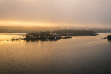 Fototapeta na wymiar Small islets in Stockholm fjords on a misty winter morning