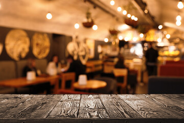 Empty wooden table in cafe. Bokeh effect