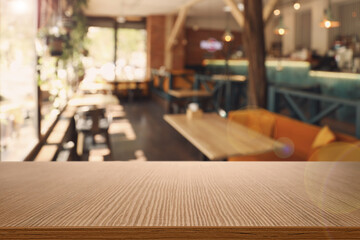 Empty wooden table in cafe. Bokeh effect
