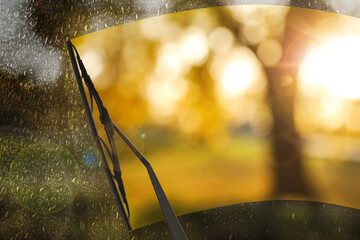 Car windshield wiper cleaning water drops from glass - obrazy, fototapety, plakaty
