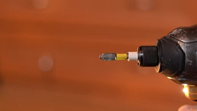Cordless screwdriver with Phillips bit rotates, close-up