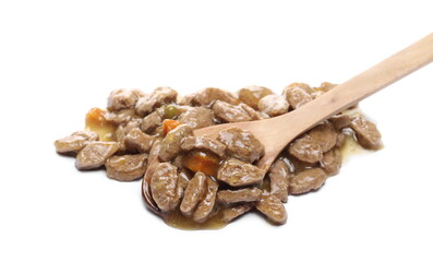 Dog food with meat and vegetables, moist granules and wooden spoon isolated on white background