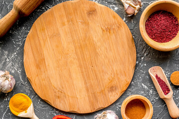 Professional kitchen with spices for cook on gray background top view