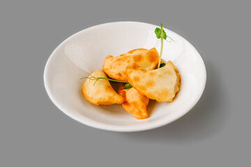 Fried Pies on plate on gray background.