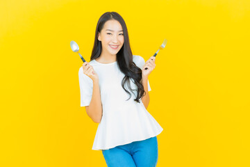 Portrait beautiful young asian woman smile with spoon and fork