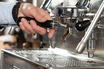 Close-up of espresso preparing in coffee machine, selective focus