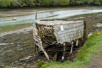 COOMBE, CORNWALL, UK - MAY 12 : Old derelict boat in the creek in Coombe,  Cornwall on May 12, 2021