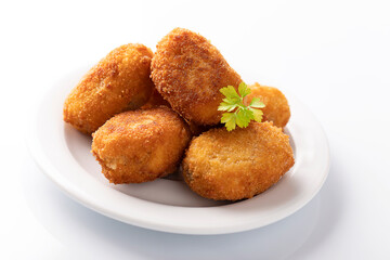 Tapa of croquetas, typical spanish dish, on white background