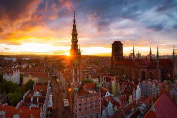 Amazing architecture of the main city in Gdansk at sunset, Poland. Aerial view of the Long Market, Main Town Hall and St. Mary Basilica - obrazy, fototapety, plakaty