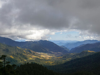 Beautiful landscape view on valley and mountains under heavy clouds from Thrumshingla pass, Mongar district, Bhutan