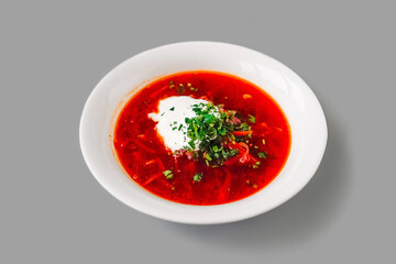 hodgepodge soup with lemon in a white plate.