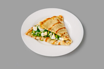 Person eating crepes with filling. Tasty breakfast.