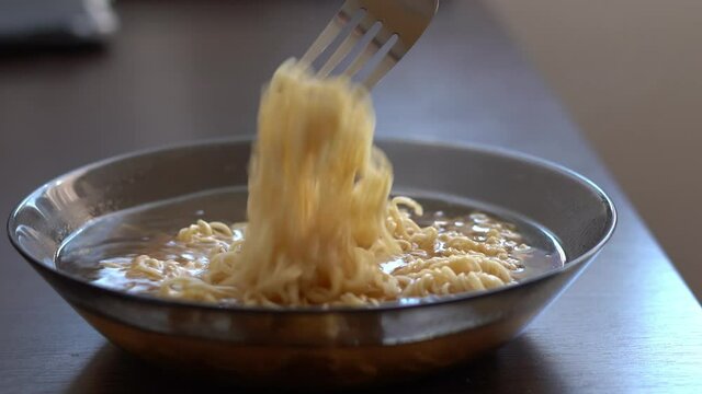 Stirring mouth-watering instant noodles with spices