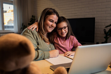 Mother and daughter learning together at home.
