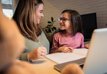 Mother and daughter learning together at home.