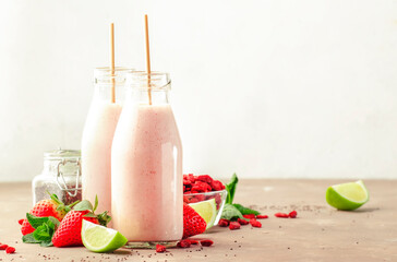 Healthy blended diet smoothie drink with strawberry and goji berries, chia seeds and lime. Glass...