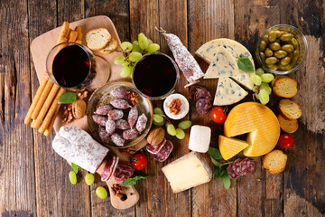 wine glasses composition with sausage, cheese and grapes