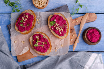 Three sandwiches with beetroot paste