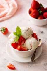 Ice cream strawberry scoop in bowl with fresh strawbery and mint