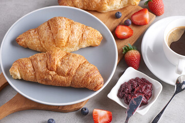 Continental breakfast with assortment of pastries, croissants, Strawberry Jam, coffees and fresh strawberries..