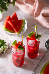 Delicious summer fruit cocktail lemonade drink with lime and mint.