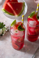 Delicious summer fruit cocktail lemonade drink with lime and mint.