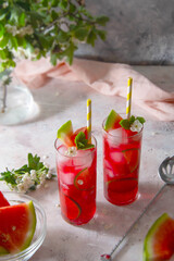 Delicious summer fruit cocktail lemonade drink with lime and mint.
