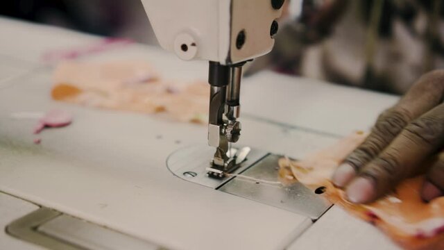 Hands Of A Tailor Doing Fabric Alteration With Sewing Machine In Tekka Centre, Singapore. close up