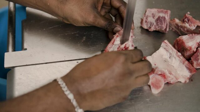 Butcher Using Machine To Cut Pieces Of Mutton In Tekka Centre, Singapore - close up