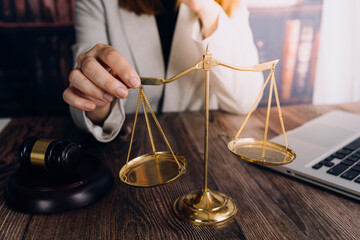 Justice and law concept.Male judge in a courtroom with the gavel, working with, computer and...