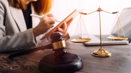 Justice and law concept.Male judge in a courtroom with the gavel, working with, computer and...