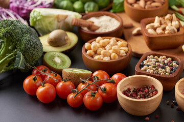 Different vegetables, seeds and fruits on table. Healthy diet..vegetarian, vegan food cooking ingredients. Flat-lay of vegetables, fruit, beans, cereals, kitchen utencil, dried flowers, top view.