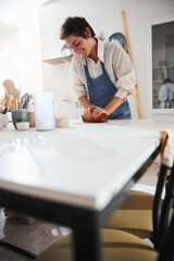 Delighted brunette woman working with soft ceramic
