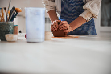 Fototapeta na wymiar Close up of woman making pottery indoors