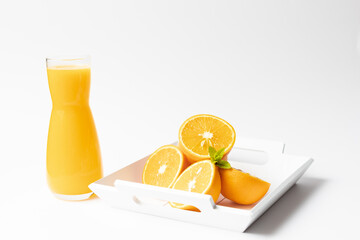 Bottle with fresh orange juice and mint.
