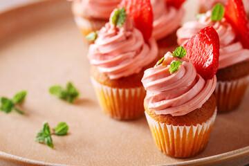 Cupcake with strawberry cream, mint leaves